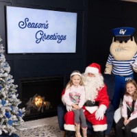 Louie the Laker and Santa with girls in pink sweaters